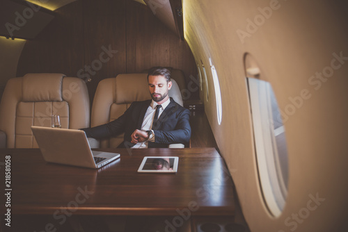 Cuadros en Lienzo Businessman flying on his private jet
