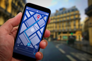 Close up of Tourist using GPS map navigation on smartphone application screen for direction to destination address in the city with travel and technology concept.