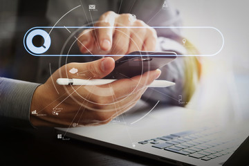 Aufkleber - close up of businessman working with mobile phone and stylus pen and laptop computer on wooden desk in modern office