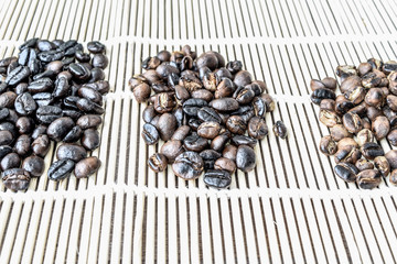 Roasted coffee beans of three different level in black bow on grunge wooden background,Coffee bean 3 level roast