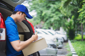 Wall Mural - Delivery man checking list on clipboard