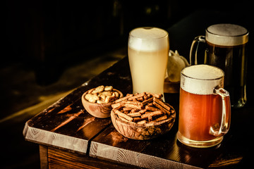 Canvas Print - Selection of different types of beer and salty snacks s in pub