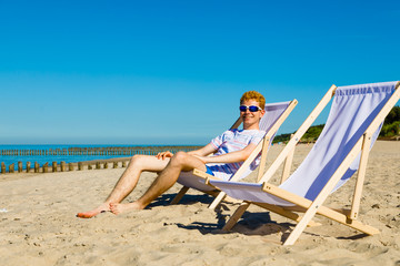 Wall Mural - Young man relaxing on beach