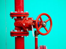 Red Water Valve On A Blue Wall