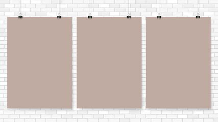 Wall Mural - Poster on binder clips. Paper templates on brick wall. Realistic mock up. Empty frames for your business design. Brick wall. Vector template for lettering, quote, images or logos.