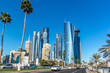Doha, Qatar - Jan 8th 2018 - The modern downtown of Doha city with palm tree, cars, wide avenues on a blue sky day in Doha City, capital of Qatar in the Middle East.