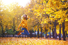  Girl In A Park Throws Yellow Leaves