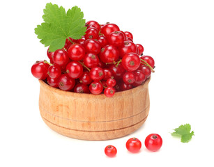 red currant in wooden bowl with green leaf isolated on white background. healthy food