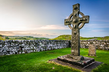 Stone Religious Celtic Kildalton Cross On A Cemetary Beside A Church On Islay Island During Sunset, Hebrides, West Scotland