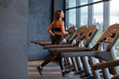 fit slim woman running on treadmill in gym
