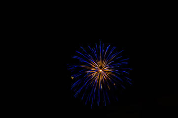 blue fireworks exploding at night