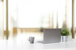 © Prathankarnpap - Workspace with laptop computer and coffee cup and plant, Stylish office desk work back view concept.