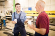 © pressmaster - Smiling young mechanic talking to his colleague during a coffee break in workshop