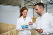 © pressmaster - Contemporary vet or engineer with tablet touching one of chicks held by his colleague during research