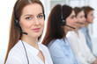 © rogerphoto - Call center. Beautiful cheerful smiling operator consulting clients with headset. Business concept of customer service