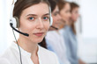 © rogerphoto - Call center. Beautiful cheerful smiling operator consulting clients with headset. Business concept of customer service