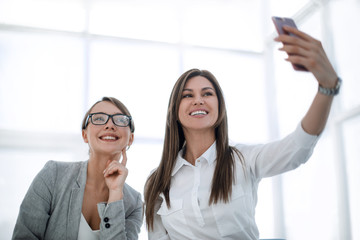 Sticker - young employees take selfies in the workplace.