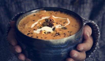 Wall Mural - Woman holding a bowl of soup food photography recipe
