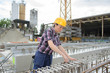 © auremar - female construction engineer inspecting construction site
