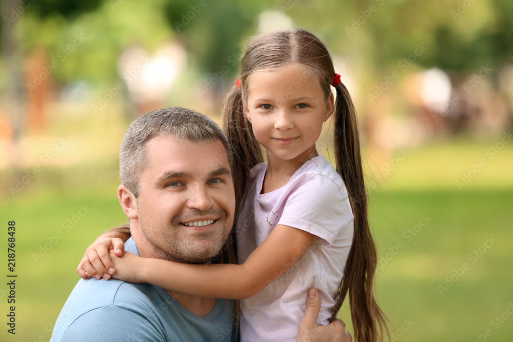 Happy father and daughter in green park