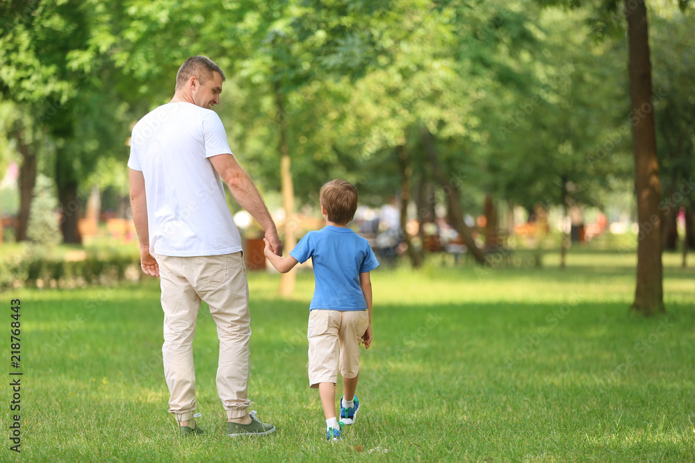 Happy father and son in green park