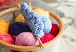 Colorful knitting yarn with needles in basket, closeup