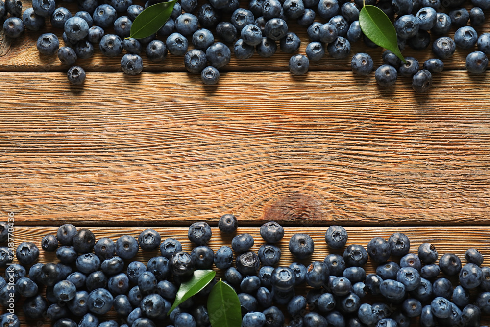 Ripe blueberries on wooden background