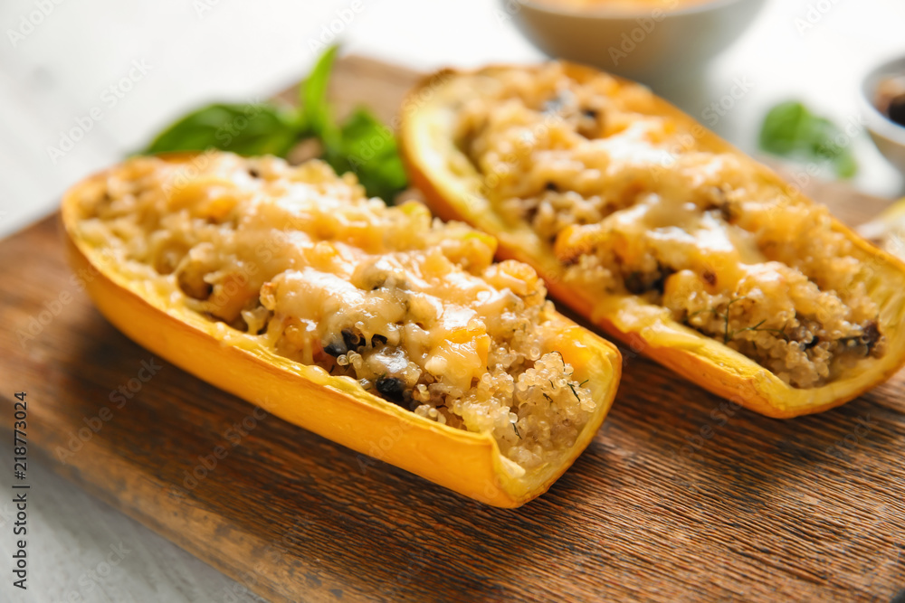 Quinoa stuffed zucchini boats on board, closeup