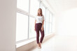 © Pixel-Shot - Young businesswoman near window in office