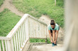 © Ivan - Determined young woman preparing for urban workout. Tying shoelaces on steps. Exercising and running in urban environment. Sport and healthy lifestyle concept