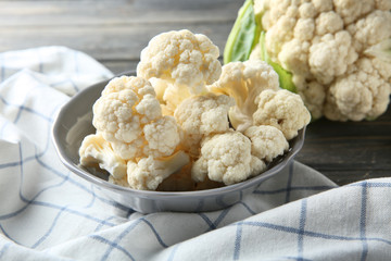 Plate with fresh cauliflower on table