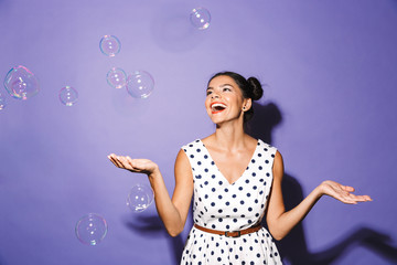 Wall Mural - Portrait of a delighted young woman in summer dress