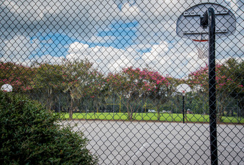 Wall Mural - Outdoor basketball Court through Fence 