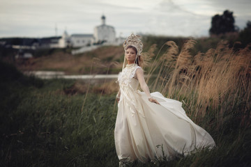 Girl in white dress on background of the Church