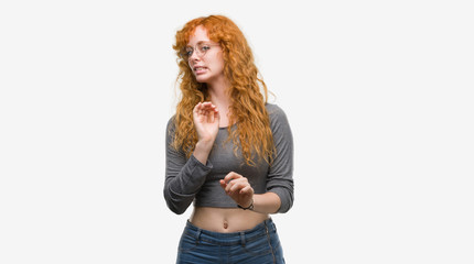 Wall Mural - Young redhead woman disgusted expression, displeased and fearful doing disgust face because aversion reaction. With hands raised. Annoying concept.