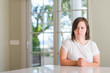 © Krakenimages.com - Down syndrome woman at home skeptic and nervous, frowning upset because of problem. Negative person.