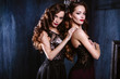 © cherry_d - Twins young women in evening dresses, fashion beauty portrait in dark interior