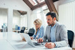 © bnenin - Close-up image of two office workers working in meeting room.