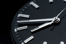 Close Up Clockwise On Black Clock Face Background. Wristwatch In Retro Style