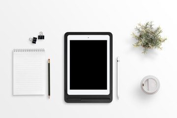 Aufkleber - Tablet with blank screen for mockup on black case on white office desk. Notepad, pencil, clips, plant, plastic cup of coffee beside. Flat lay.