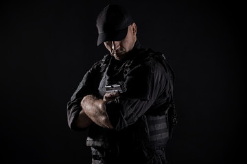 Spec ops police officer SWAT in black uniform