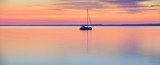 The world at rest - sailing boat in calm lake at sunset