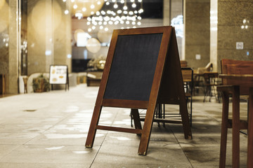Wall Mural - Close up of sandwich board next to restaurant.
