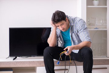 Man trying to fix broken tv