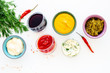 Different dip sauce in bowls near chili pepper and greenery. Ketchup, mayonnaise, mustard, soy sauce, barbecue sauce, pesto, mustard, sour on white background top view copy space
