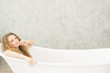 © pic for you - Young woman relaxing in bath.beautiful woman lying in bathtub.