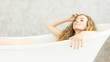 © pic for you - Young woman relaxing in bath.beautiful woman lying in bathtub.