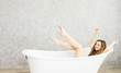 © pic for you - Young woman relaxing in bath.beautiful woman lying in bathtub.