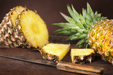 sliced pineapple on wooden background