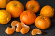 Citrus fruit background with orange, tangerine and lemon fruit on rustic black table top